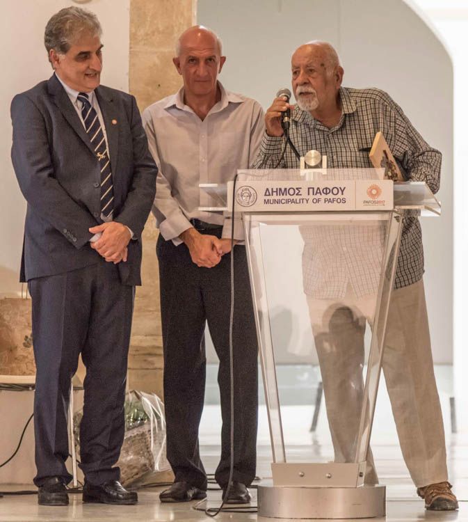 Fig. 42. Dafnis is shown accepting the "Father of the Environment" award from two government officials.